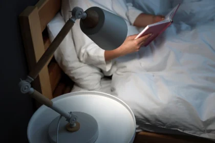 Woman reading a book before sleep at night as part of CBT for insomnia routine