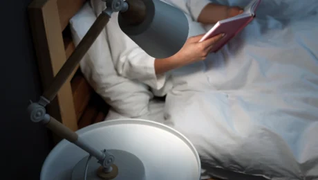 Woman reading a book before sleep at night as part of CBT for insomnia routine Woman reading a book before sleep at night as part of CBT for insomnia routine