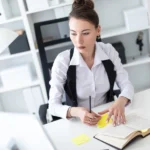 Worker at office managing stress with CBT tools