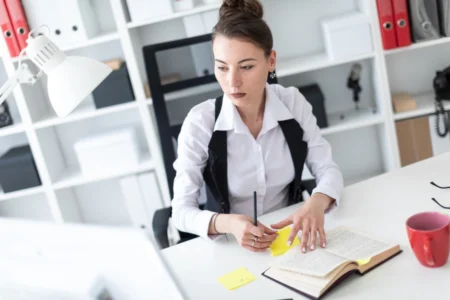 Worker at office managing stress with CBT tools