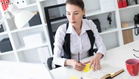 Worker managing stress with cbt tools Worker at office managing stress with CBT tools